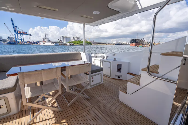 Slide: The Image of Luxurious 2019 Azimut 66 yacht deck with seating, table, and ocean view. - 30