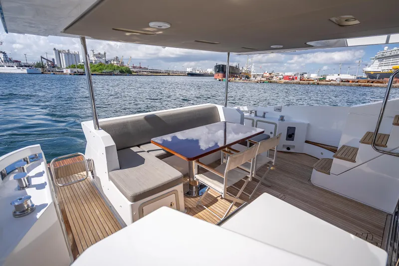 Slide: The Image of Luxurious 2019 Azimut 66 yacht deck with seating, table, and ocean view. - 32