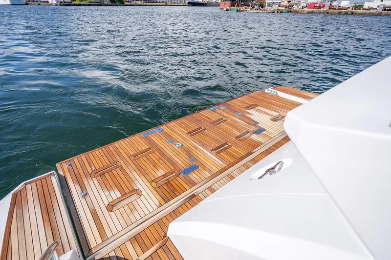Slide: The Image of 2019 Azimut 66 yacht with teak swim platform on calm water. - 33