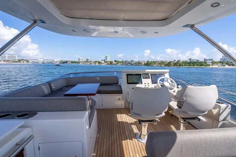 Slide: The Image of 2019 Azimut 66 yacht cockpit with seating, helm, and ocean view. - 44