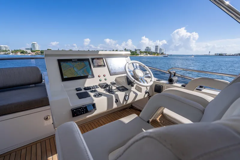 Slide: The Image of Luxurious 2019 Azimut 66 yacht helm with navigation screens, steering wheel, and ocean view. - 45