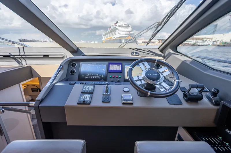 Slide: The Image of Cockpit of 2019 Azimut 66 yacht with modern navigation controls and steering wheel. - 64