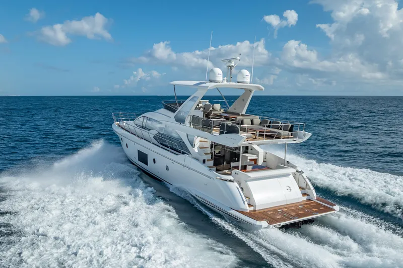 Slide: The Image of Luxurious 2019 Azimut 66 yacht cruising on open sea under clear blue sky. - 7