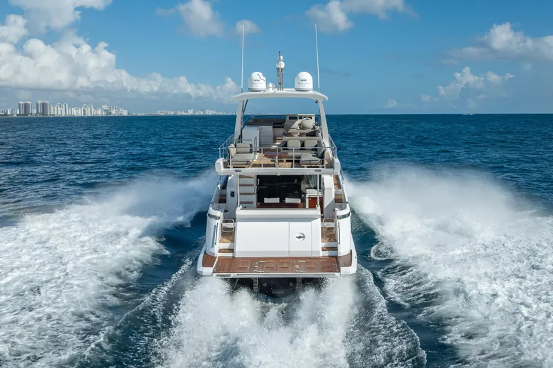 Slide: The Image of Azimut 66 yacht cruising on open sea, 2019 model, with city skyline in background. - 8