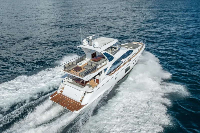 Slide: The Image of Luxurious 2019 Azimut 66 yacht cruising on open sea, showcasing elegant design and spacious deck. - 9