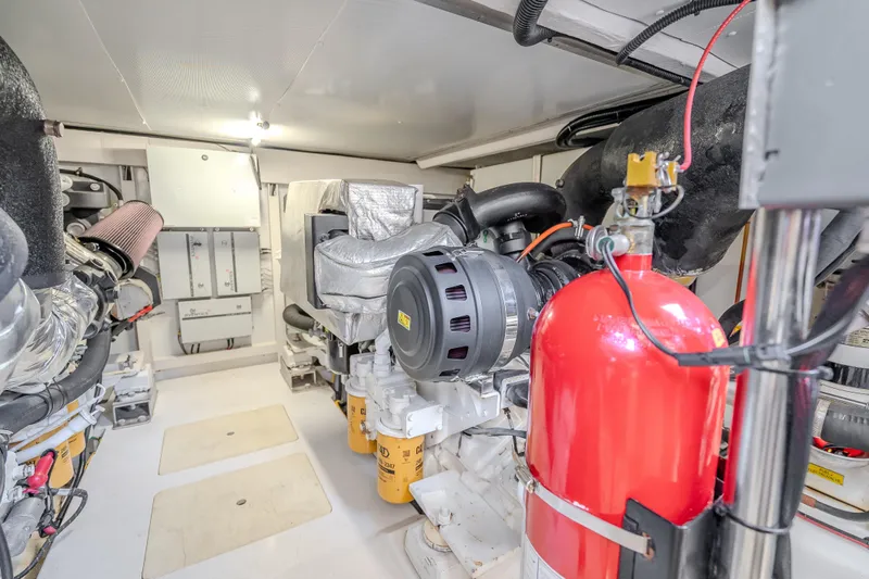 Slide: The Image of Engine room of 2019 Azimut 66 yacht, featuring machinery and fire extinguisher. - 92