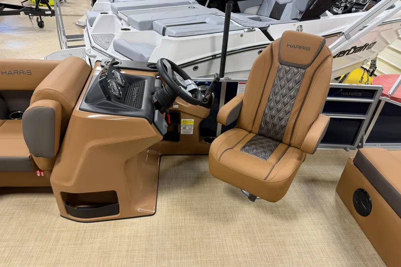 Slide: The Image of 2026 Harris Cruiser 190 boat interior with tan seating and steering console. - 4