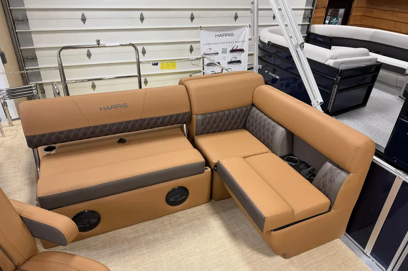 Slide: The Image of 2026 Harris Cruiser 190 pontoon boat interior with tan seating and cup holders. - 6