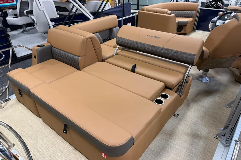 Slide: The Image of 2026 Harris Cruiser 190 boat interior with tan seating and cup holders. - 7