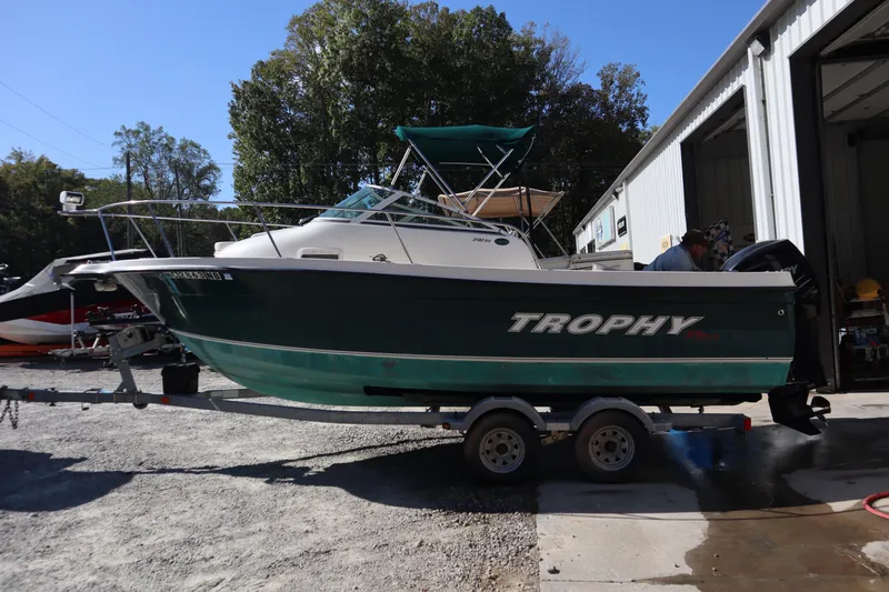 The Image of 2008 Trophy 2102 Walkaround boat on trailer, parked outside a garage. - 0