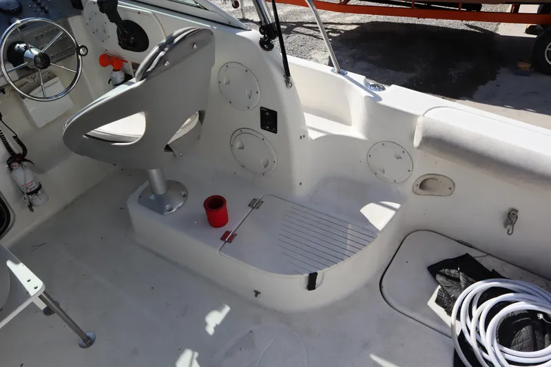Slide: The Image of 2008 Trophy 2102 Walkaround boat interior with steering wheel and seating area. - 10