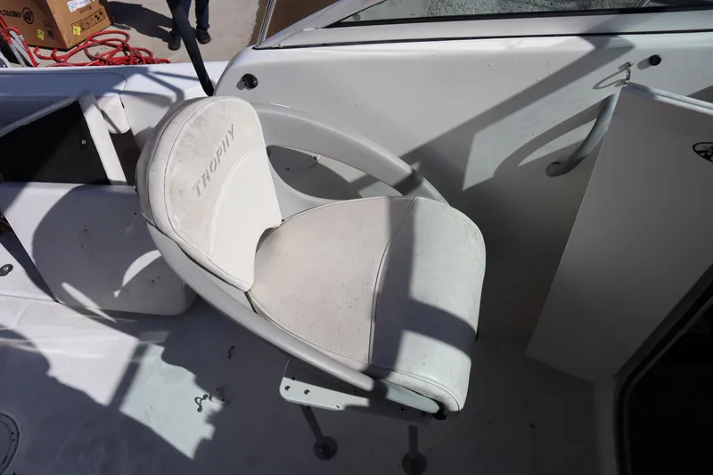 Slide: The Image of 2008 Trophy 2102 Walkaround boat seat with "Trophy" branding, white upholstery. - 7