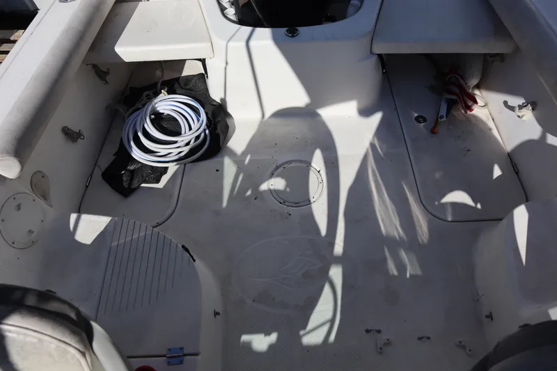 Slide: The Image of 2008 Trophy 2102 Walkaround boat interior with coiled rope and storage compartments. - 9
