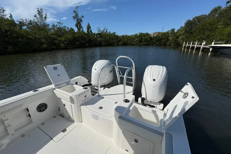 Slide: The Image of 2026 World Cat 235 TE boat with dual engines on a serene waterway. - 10