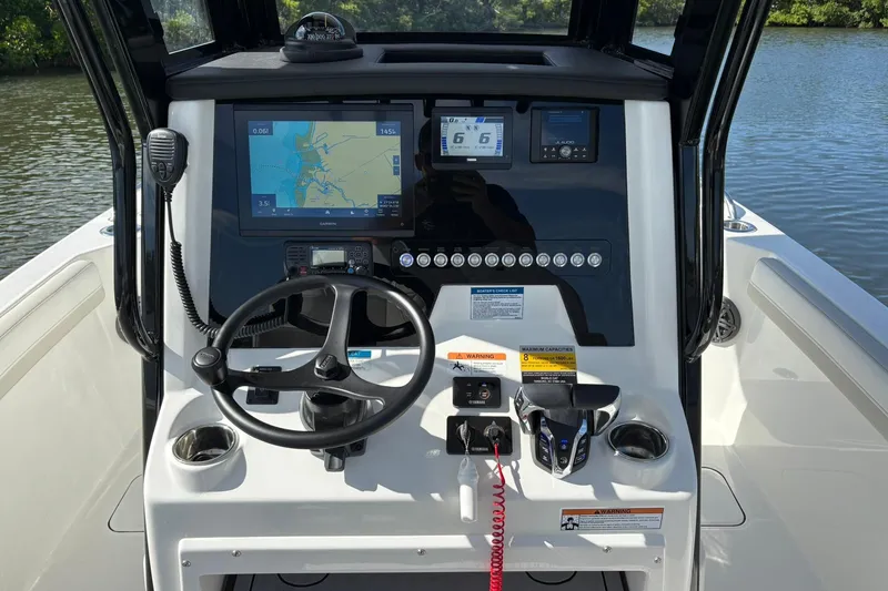 Slide: The Image of 2026 World Cat 235 TE boat dashboard with navigation and control systems. - 15