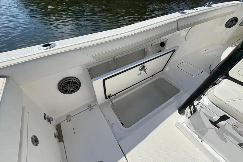 Slide: The Image of 2026 World Cat 235 TE boat interior with open storage compartment and speaker. - 23