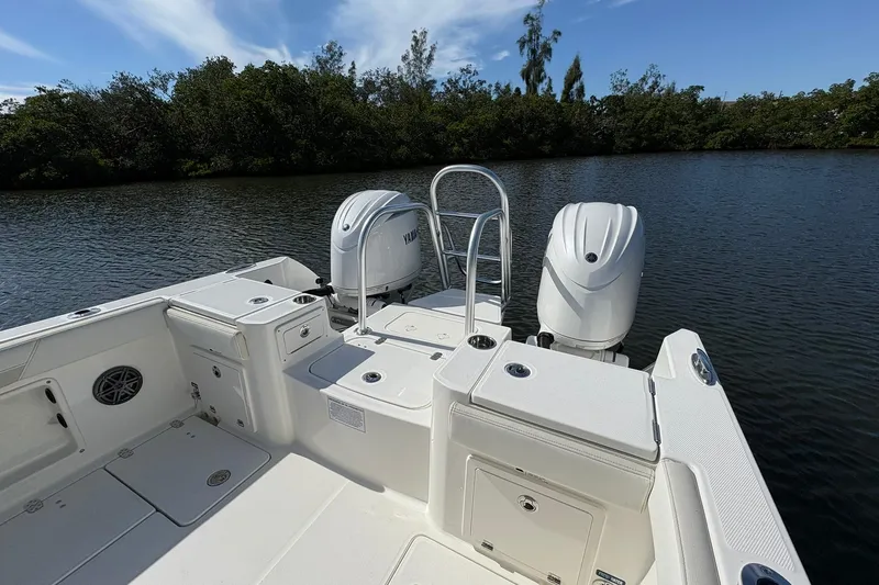 Slide: The Image of 2026 World Cat 235 TE boat with dual Yamaha engines on a calm lake. - 9