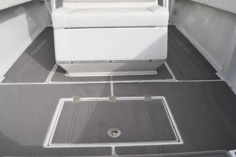 Slide: The Image of 1993 Fountain 27 Center Console boat interior with gray flooring and white seating. - 50