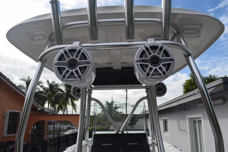 Slide: The Image of 1993 Fountain 27 Center Console boat with speakers and Garmin equipment, under a clear sky. - 62