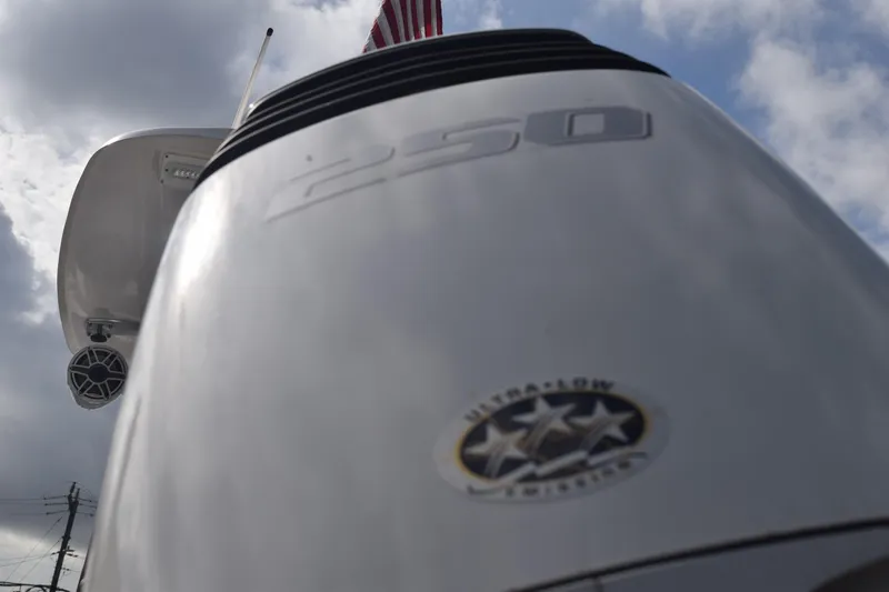 Slide: The Image of Close-up of a 1993 Fountain 27 Center Console boat engine under cloudy sky. - 96