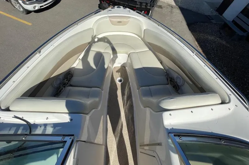 Slide: The Image of 2004 Chaparral 256 SSi boat interior with beige seating and speaker system. - 10