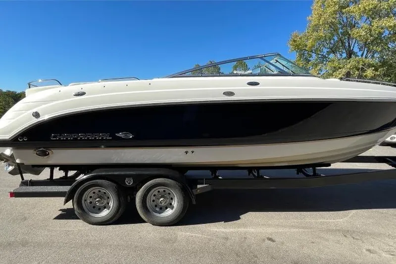 Slide: The Image of 2004 Chaparral 256 SSi boat on trailer, black and white design, sunny day. - 2
