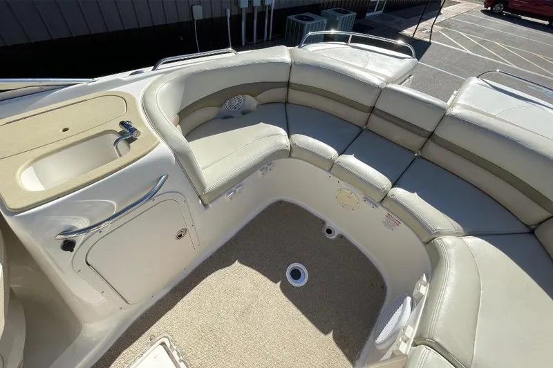 Slide: The Image of 2004 Chaparral 256 SSi boat interior with beige seating and built-in sink. - 4