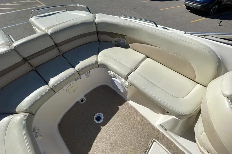 Slide: The Image of 2004 Chaparral 256 SSi boat interior with beige seating and carpeted floor. - 5