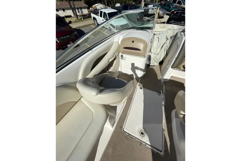 Slide: The Image of 2004 Chaparral 256 SSi boat interior with white seating and open deck layout. - 6