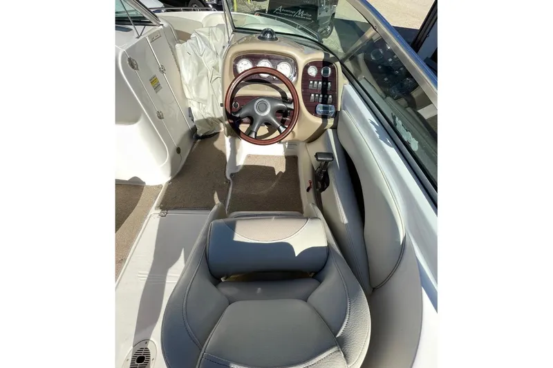 Slide: The Image of 2004 Chaparral 256 SSi boat interior with steering wheel and dashboard controls. - 7