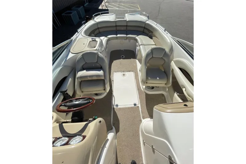 Slide: The Image of 2004 Chaparral 256 SSi boat interior with seating and steering wheel. - 8