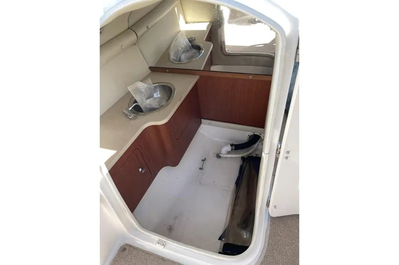Slide: The Image of 2004 Chaparral 256 SSi boat interior with sink and storage area. - 9