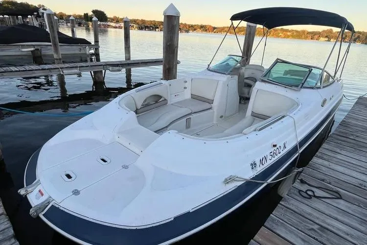 The Image of 2002 Four Winns 264 Funship boat docked on a serene lake. - 1