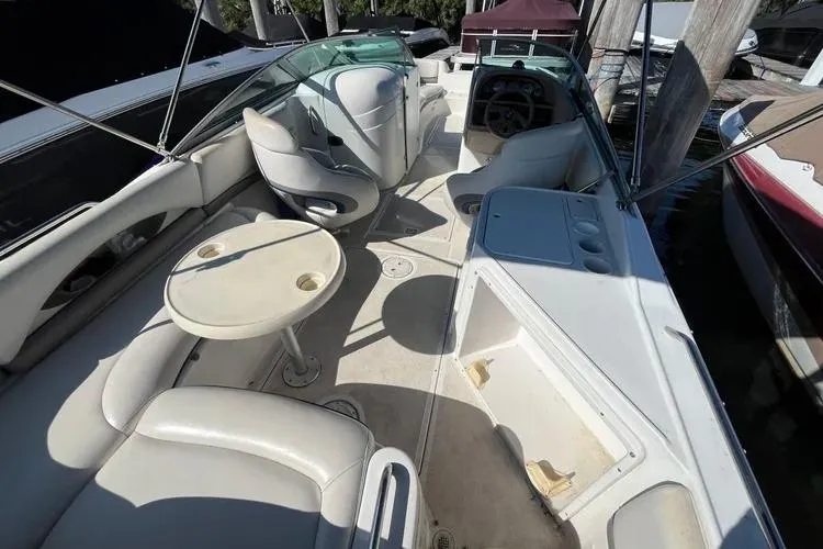 Slide: The Image of 2002 Four Winns 264 Funship boat interior with seating, table, and helm. - 11