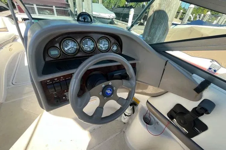 Slide: The Image of 2002 Four Winns 264 Funship boat dashboard with steering wheel and gauges. - 13