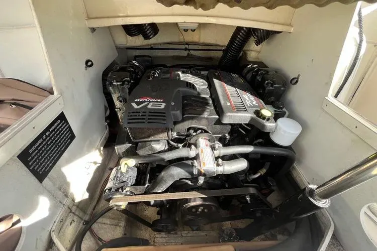 Slide: The Image of Engine compartment of a 2002 Four Winns 264 Funship boat, featuring a V8 engine. - 21