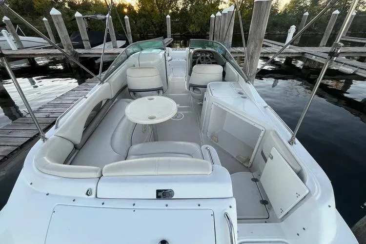 Slide: The Image of 2002 Four Winns 264 Funship boat interior with seating and table at dock. - 5