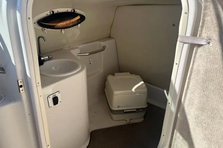 Slide: The Image of 2002 Four Winns 264 Funship boat interior with sink and portable toilet. - 9