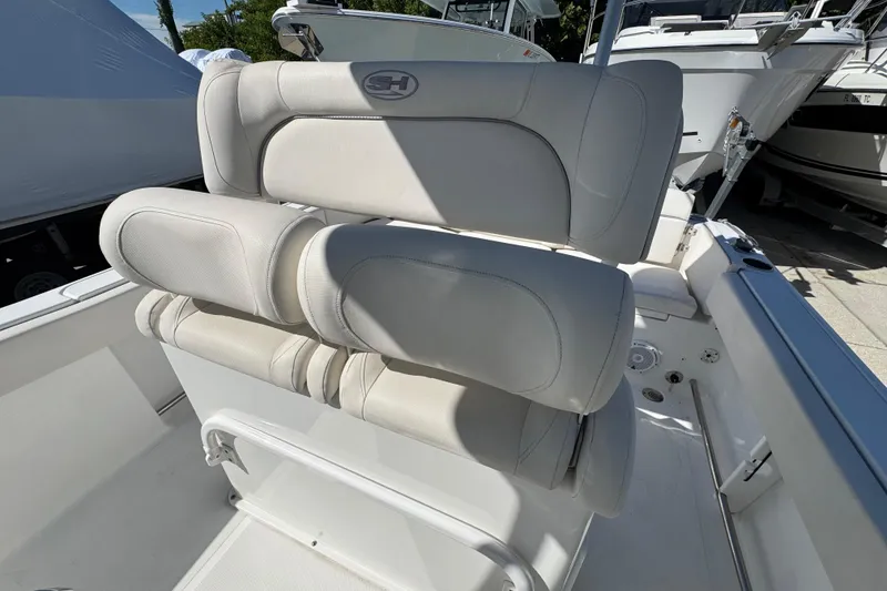 Slide: The Image of 2023 Sea Hunt Ultra 229 boat seating with white cushioned upholstery. - 11