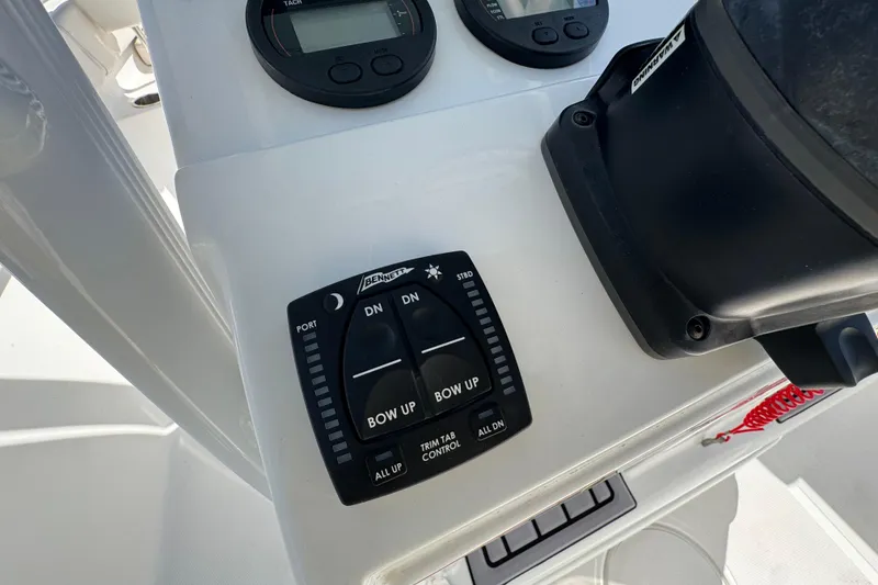 Slide: The Image of Control panel on 2023 Sea Hunt Ultra 229 boat with trim tab switches. - 13