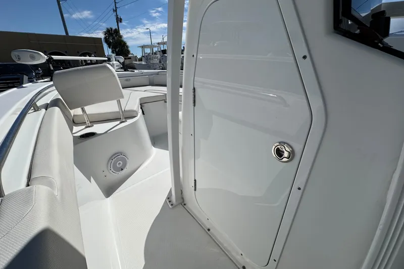 Slide: The Image of 2023 Sea Hunt Ultra 229 boat interior with seating and storage compartment. - 14