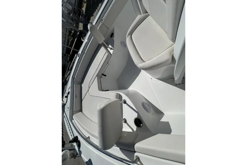 Slide: The Image of 2023 Sea Hunt Ultra 229 boat interior with white seating and sleek design. - 16