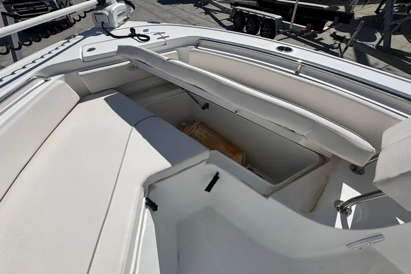 Slide: The Image of 2023 Sea Hunt Ultra 229 boat interior with open storage compartment. - 17