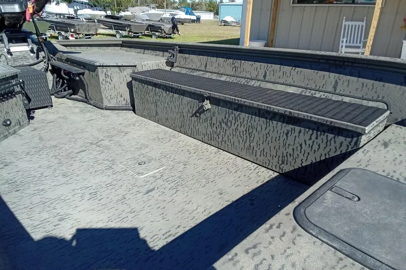 Slide: The Image of 2020 War Eagle 750 Gladiator boat interior with storage compartments and camouflage design. - 12