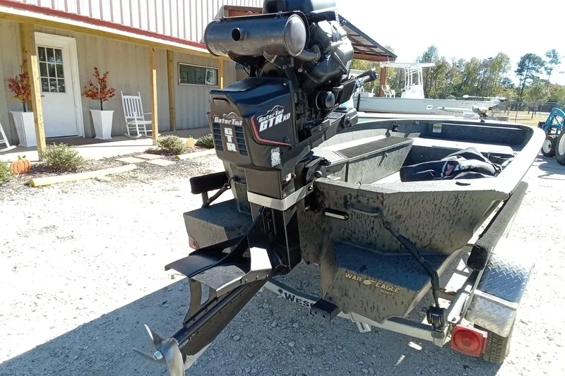 Slide: The Image of 2020 War Eagle 750 Gladiator boat with GatorTail motor, parked outdoors. - 16