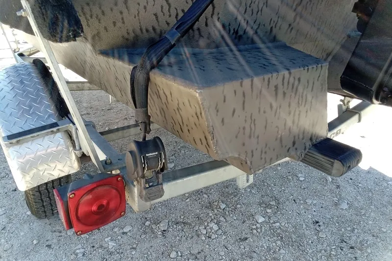 Slide: The Image of Rear view of 2020 War Eagle 750 Gladiator boat on trailer, featuring camo design. - 17