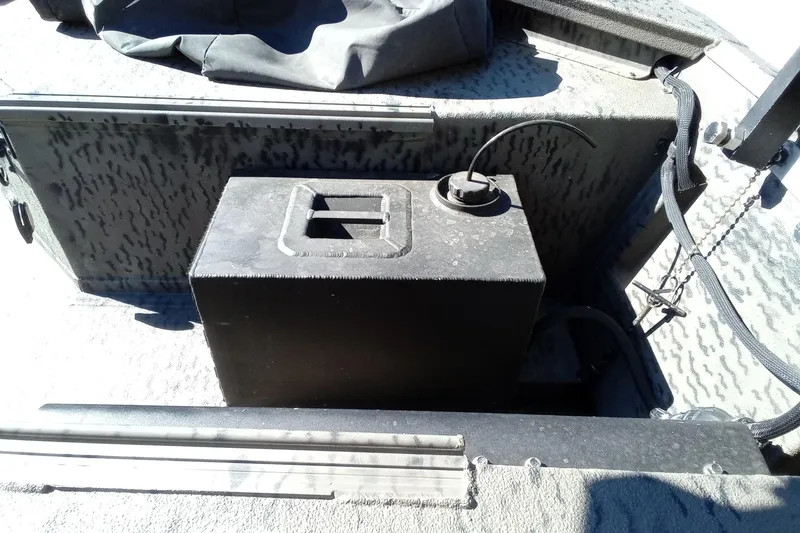 Slide: The Image of Interior of a 2020 War Eagle 750 Gladiator boat showing a battery compartment. - 18