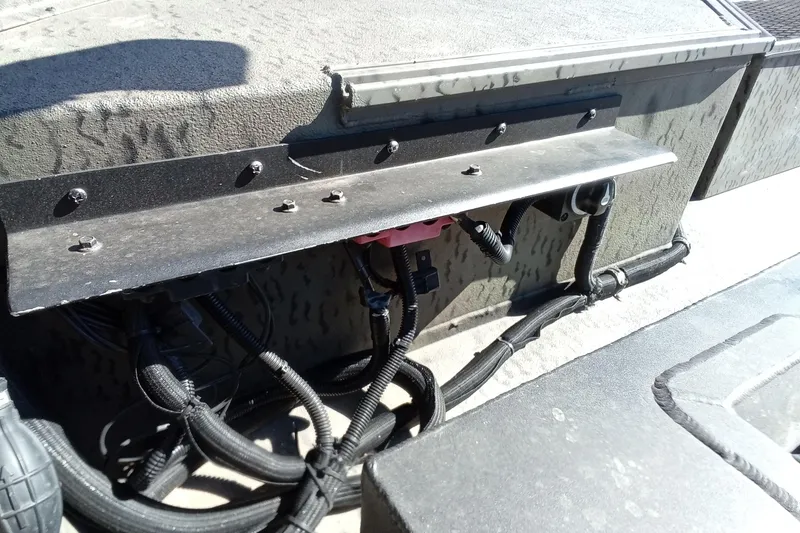 Slide: The Image of 2020 War Eagle 750 Gladiator boat wiring and components under a metal panel. - 19