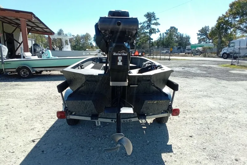 Slide: The Image of 2020 War Eagle 750 Gladiator boat on trailer, rear view in outdoor setting. - 20