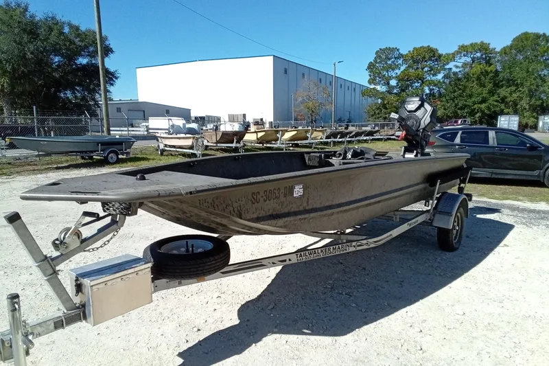 Slide: The Image of 2020 War Eagle 750 Gladiator boat on trailer in outdoor setting. - 23